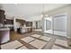 Sunlit dining area with hardwood floors and views of the kitchen and backyard, perfect for Gathering gatherings at 17054 Hop Clover Ave, Parker, CO 80134