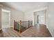 Welcoming entryway boasts hardwood floors and staircase with wood and wrought iron railing at 17054 Hop Clover Ave, Parker, CO 80134