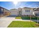 Charming single-Gathering home with white brick and siding, a well-manicured lawn, and a two-car garage at 17054 Hop Clover Ave, Parker, CO 80134