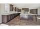 Spacious kitchen with dark wood cabinets, a large island, and modern appliances, offering ample counter space at 17054 Hop Clover Ave, Parker, CO 80134