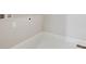 This laundry room features white walls and baseboards and vinyl flooring at 17054 Hop Clover Ave, Parker, CO 80134