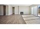 Spacious living area featuring wood floors, a fireplace, and sliding glass doors, providing ample natural light and access at 17054 Hop Clover Ave, Parker, CO 80134