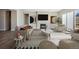 Modern living room with stylish furniture, a fireplace, large windows, and contemporary artwork creating an inviting space at 17054 Hop Clover Ave, Parker, CO 80134