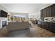 Open-concept living space with large windows, hardwood floors, a fireplace, and stylish decor, perfect for entertaining at 17054 Hop Clover Ave, Parker, CO 80134