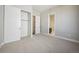 Spacious bedroom with plush carpet and walk-in closet adjacent to the main bathroom at 17054 Hop Clover Ave, Parker, CO 80134