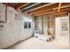 Unfinished basement with exposed insulation and shelving at 1315 Laurel St, Broomfield, CO 80020