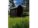 Quaint cabin with dark siding, stairs, and a small landing at 27447 Upper Cold Spg Gulch Rd, Golden, CO 80401
