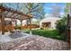 Backyard patio with a wooden pergola, dining table, and chairs at 1474 S Emerson St, Denver, CO 80210