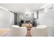Basement living room with a gray sofa and bright white chairs at 1474 S Emerson St, Denver, CO 80210