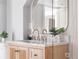 Bright bathroom featuring a wood vanity with a marble countertop and gold fixtures at 1474 S Emerson St, Denver, CO 80210