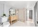 Stylish bathroom with a glass shower, wood vanity, and tile flooring at 1474 S Emerson St, Denver, CO 80210