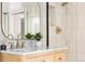 Close up of bathroom featuring wood vanity, gold fixtures and glass enclosed shower at 1474 S Emerson St, Denver, CO 80210