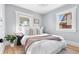 Calm bedroom with neutral colors, bright windows, and comfortable bedding at 1474 S Emerson St, Denver, CO 80210