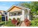 Charming home with manicured lawn, steps to porch, and inviting curb appeal, with landscaping at 1474 S Emerson St, Denver, CO 80210