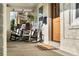 Inviting front porch featuring comfortable rocking chairs, textured brick, and a welcoming entrance at 1474 S Emerson St, Denver, CO 80210