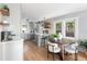 Open kitchen with modern appliances, a central island, and a dining area filled with natural light at 1474 S Emerson St, Denver, CO 80210