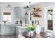 Bright kitchen featuring gray cabinetry, a farm sink, open shelving, and stylish pendant lighting at 1474 S Emerson St, Denver, CO 80210