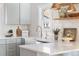 Bright kitchen with a farm sink, quartz countertop, and open shelving, with brass colored hardware at 1474 S Emerson St, Denver, CO 80210