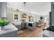 Bright eat-in kitchen with stainless appliances, farmhouse sink, and floating shelves at 1474 S Emerson St, Denver, CO 80210