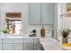 Beautiful kitchen featuring gray cabinetry, a farm sink, and quartz countertops with modern appliances at 1474 S Emerson St, Denver, CO 80210