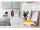 Modern kitchen featuring a farm sink, quartz countertops, and sleek stainless steel appliances at 1474 S Emerson St, Denver, CO 80210