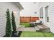 Outdoor patio space with cozy seating area and artificial turf at 10384 E 60Th Pl, Denver, CO 80238
