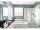 Bathroom showcasing a soaking tub, frameless glass shower and modern fixtures at 10384 E 60Th Pl, Denver, CO 80238