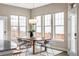 Bright dining area with large windows and modern chandelier at 10384 E 60Th Pl, Denver, CO 80238