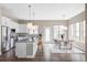 Modern kitchen with white cabinetry, granite countertops, stainless steel appliances, and island seating at 10384 E 60Th Pl, Denver, CO 80238
