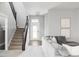 Open floor plan with stairs and comfortable seating at 10384 E 60Th Pl, Denver, CO 80238