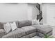 Basement living room featuring a large sectional sofa and staircase at 10384 E 60Th Pl, Denver, CO 80238