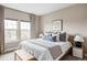 Calm main bedroom with a king bed, soft blue accents, and bright natural light at 10384 E 60Th Pl, Denver, CO 80238