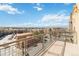 A spacious balcony with beautiful neighborhood views of surrounding buildings and blue skies at 9079 E Panorama Cir # 520, Englewood, CO 80112