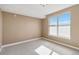 Light-filled room with a large window, neutral carpet and trim at 9079 E Panorama Cir # 520, Englewood, CO 80112