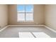Bright, empty room with large window and soft carpeting, ready for personalization at 9079 E Panorama Cir # 520, Englewood, CO 80112