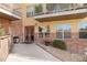 Exterior entrance to building shows a brick facade, walkway, and updated windows and balconies at 9079 E Panorama Cir # 520, Englewood, CO 80112