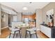 Dining area features a round table set for four, leading to the kitchen with stainless appliances at 9079 E Panorama Cir # 520, Englewood, CO 80112