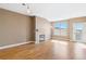 Bright living area featuring hardwood floors, a fireplace, and balcony with neutral-colored walls at 9079 E Panorama Cir # 520, Englewood, CO 80112
