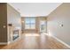 Open living area with hardwood floors, a fireplace, and a balcony for natural light at 9079 E Panorama Cir # 520, Englewood, CO 80112