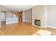 Open living area with a fireplace, hardwood flooring, and a glimpse of the kitchen at 9079 E Panorama Cir # 520, Englewood, CO 80112