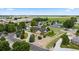 Aerial view of a charming neighborhood featuring lush green trees and well-manicured lawns at 8007 Sunrise Cir, Frederick, CO 80516