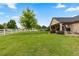 Well-maintained backyard with mature trees, white fencing, and covered patio, ideal for relaxation and entertaining at 8007 Sunrise Cir, Frederick, CO 80516