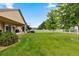 Expansive backyard with lush lawn, mature trees, and white fencing, perfect for outdoor activities at 8007 Sunrise Cir, Frederick, CO 80516