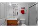 Well-lit bathroom with sink, toilet, and glass-enclosed shower, featuring simple and clean design elements at 8007 Sunrise Cir, Frederick, CO 80516