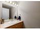 Powder room featuring a decorative mirror and vanity sink at 8007 Sunrise Cir, Frederick, CO 80516