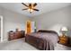 Neutral bedroom with a comfortable bed, dresser, and a nightstand with lamps at 8007 Sunrise Cir, Frederick, CO 80516