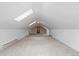 Spacious, carpeted bonus room featuring bright skylights and a versatile floorplan at 8007 Sunrise Cir, Frederick, CO 80516