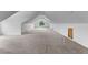 Expansive bonus room with pitched ceilings, natural light from a window, and neutral carpet flooring at 8007 Sunrise Cir, Frederick, CO 80516