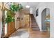Spacious foyer with a wooden front door, hardwood floors, staircase, and arched doorway at 8007 Sunrise Cir, Frederick, CO 80516