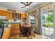 Eat-in kitchen with hardwood floors, ceiling fan, breakfast table, and door to outdoors at 8007 Sunrise Cir, Frederick, CO 80516